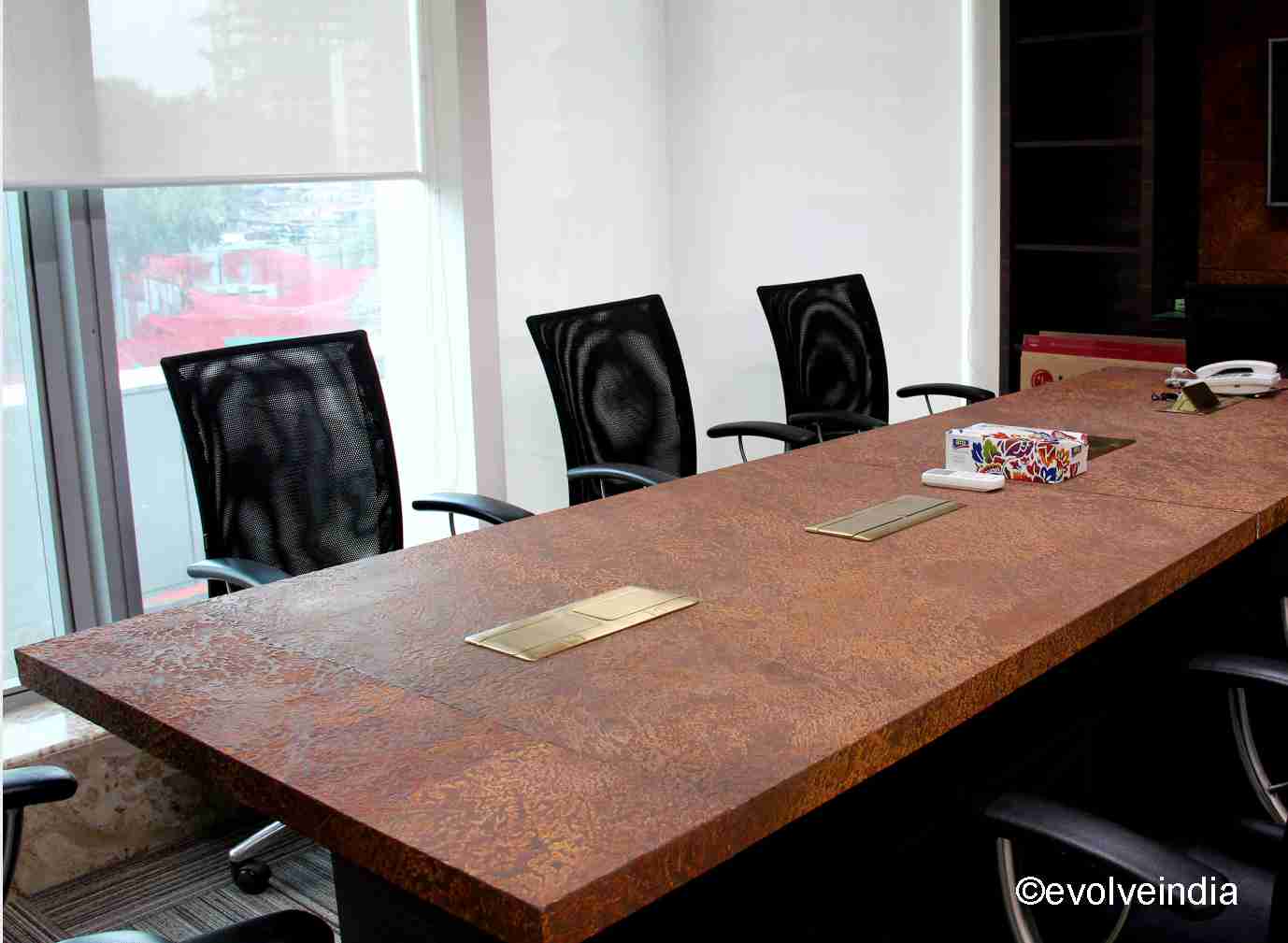 Conference table designed using liquid metal rust finish by Evolve India