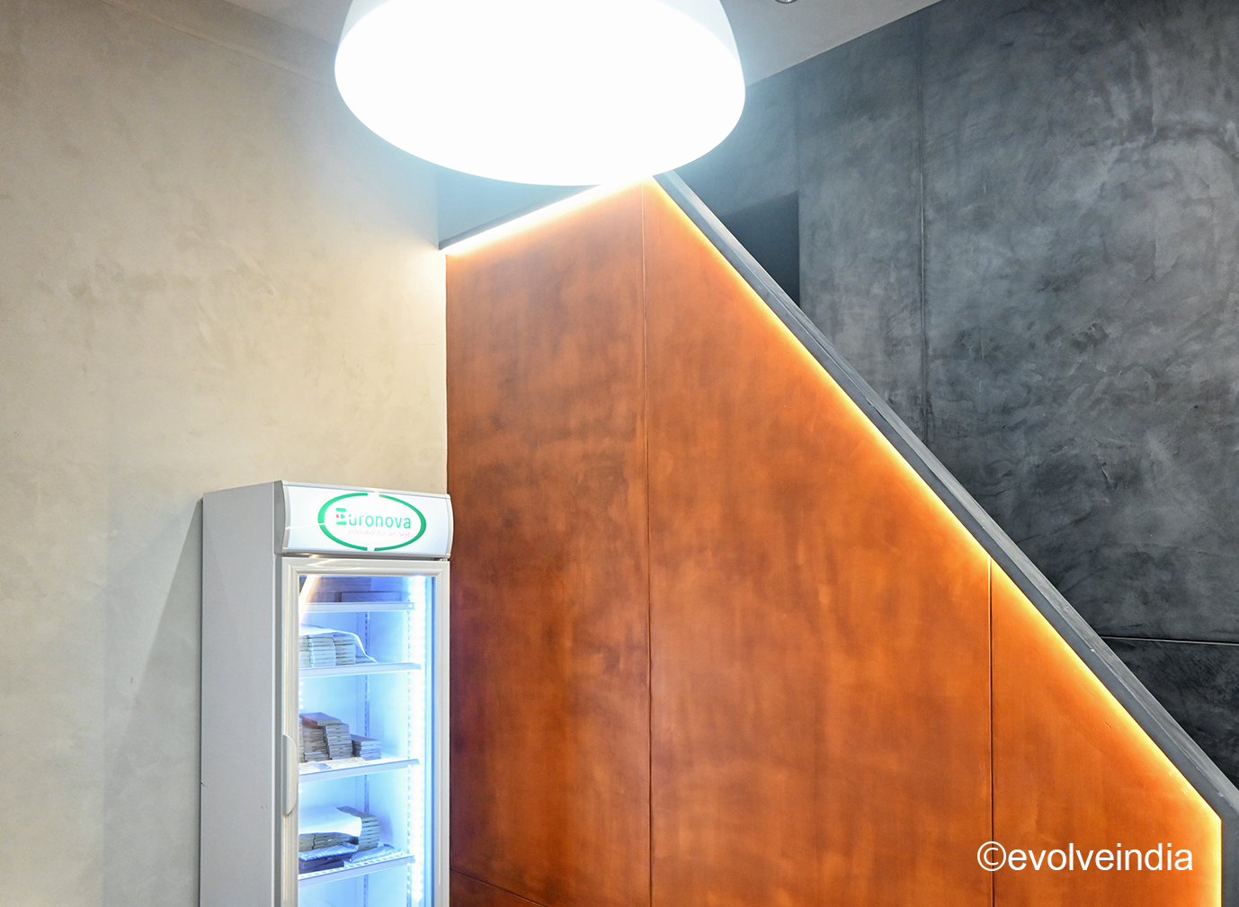 Seamless wall designed using corten steel finish and decorative concrete finish by Evolve India