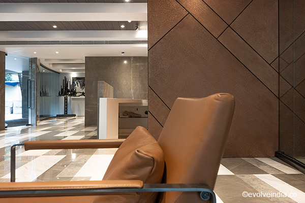 Office reception interior designed with Evolve India's liquid metal copper