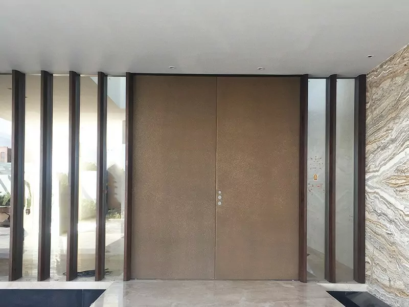 Modern door design by Evolve India, finished using bronze liquid metal coating