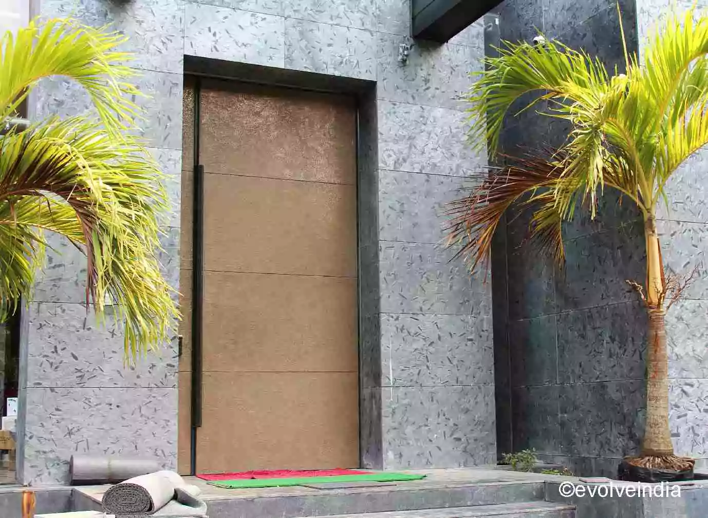 entrance door designed with liquid metal brass finish by Evolve India