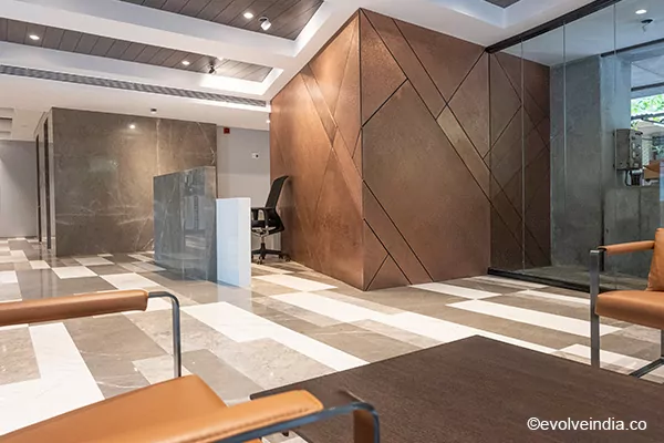 Office reception interior designed with Evolve India's liquid metal copper