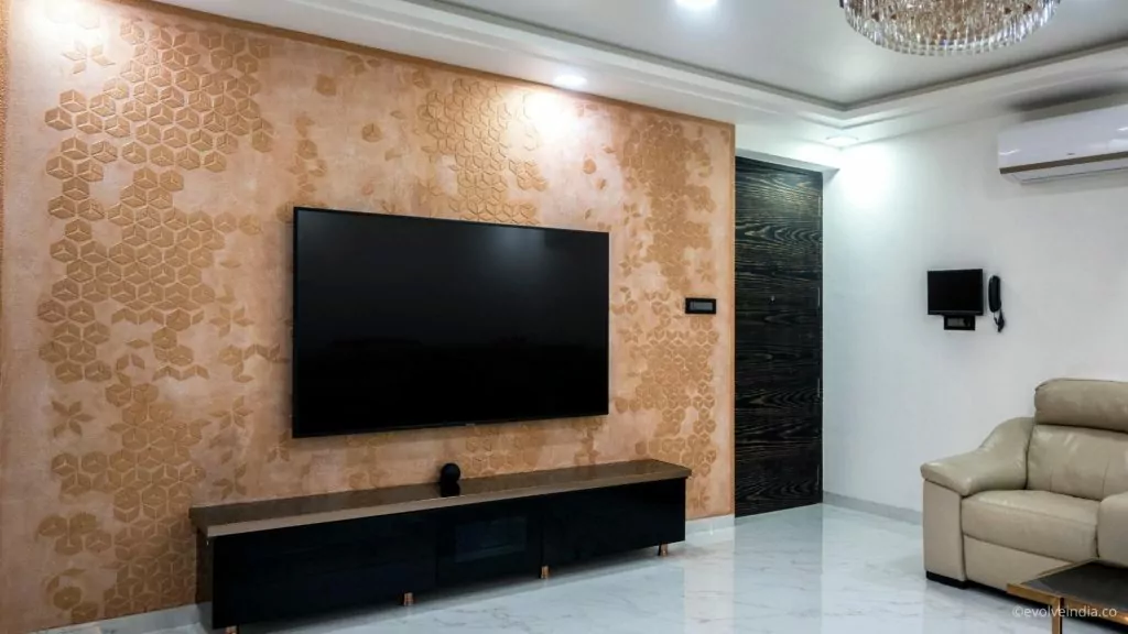 TV backdrop designed using decorative concrete finish by Evolve India