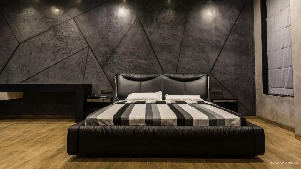 Bedroom wall designed using decorative concrete finish by Evolve India