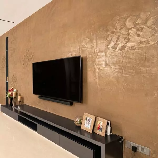 Living room wall designed using liquid metal bronze finish